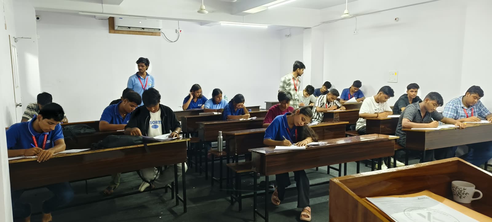 Students writing the weekly test in the exam hall